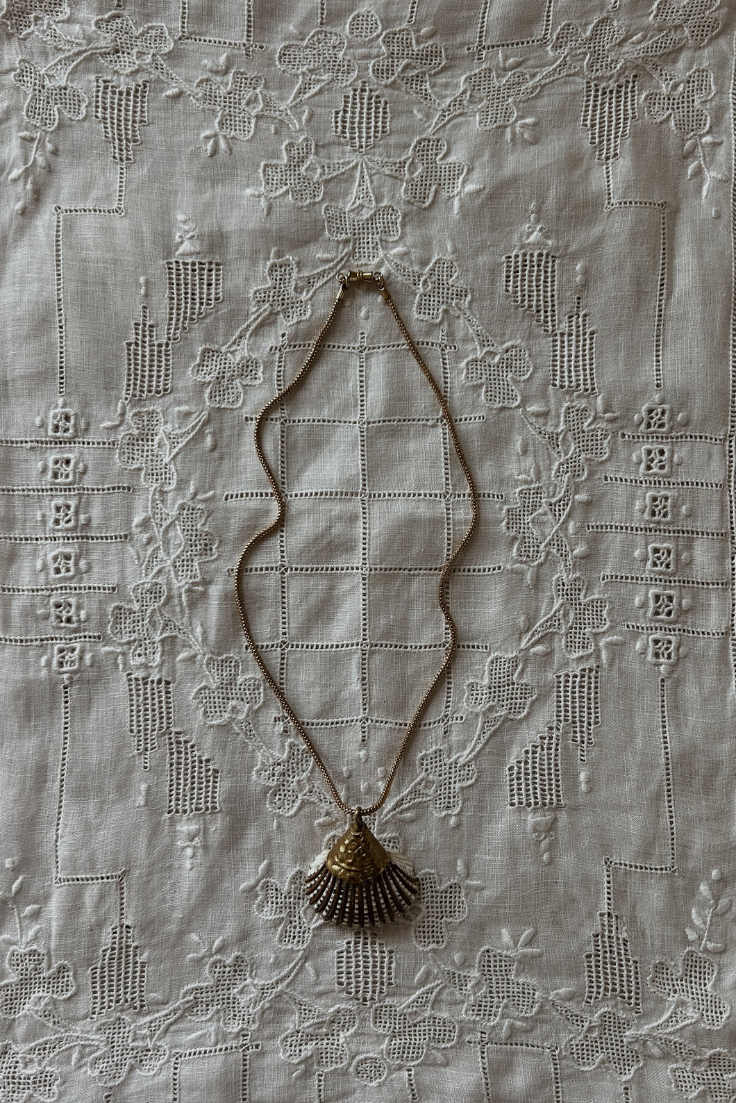 1980's BRASS COATED SHELL PENDANT ON GOLD VERMEIL CHAIN