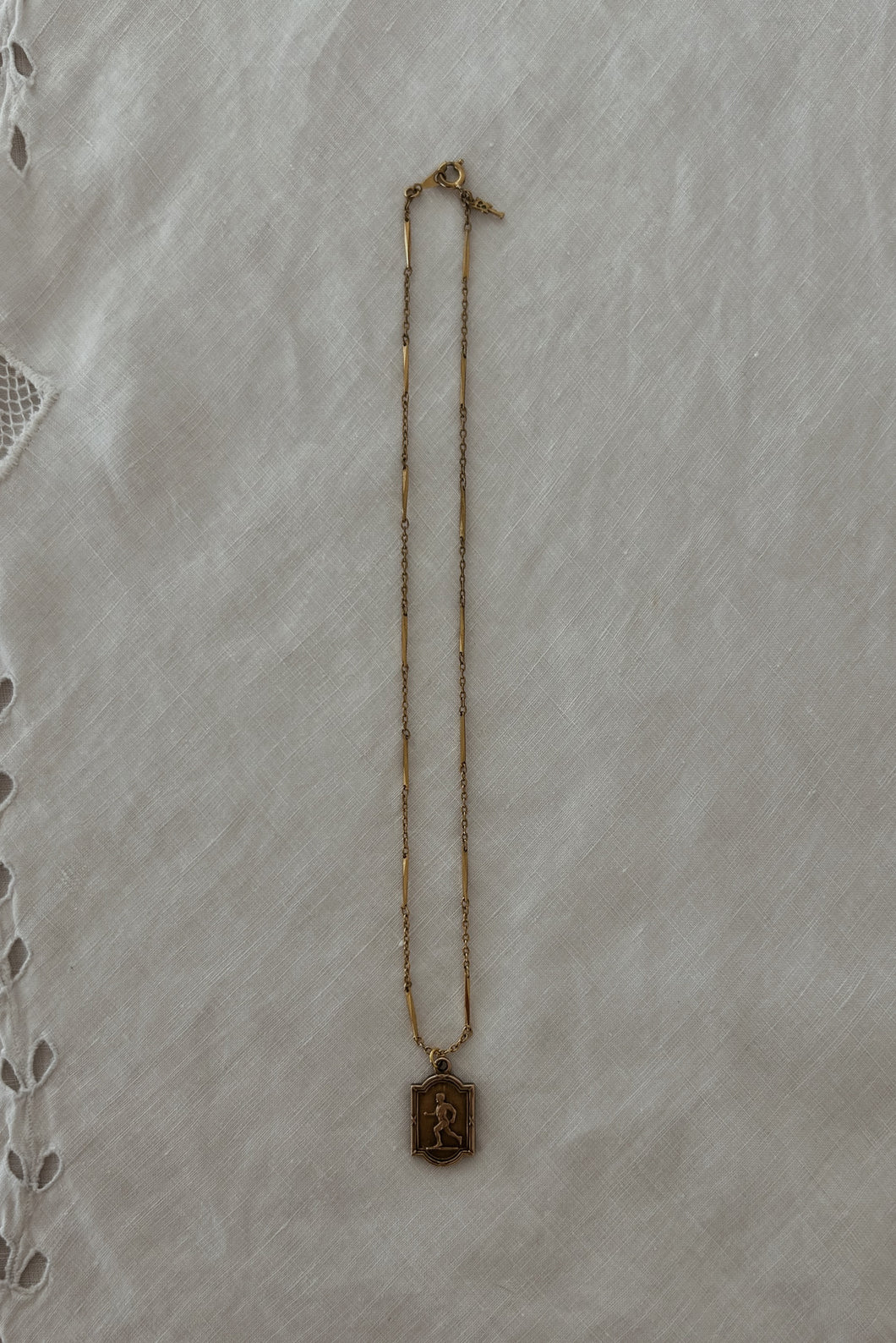 1930's BRASS RUNNER PENDANT ON 1970's GOLD FILL CHAIN