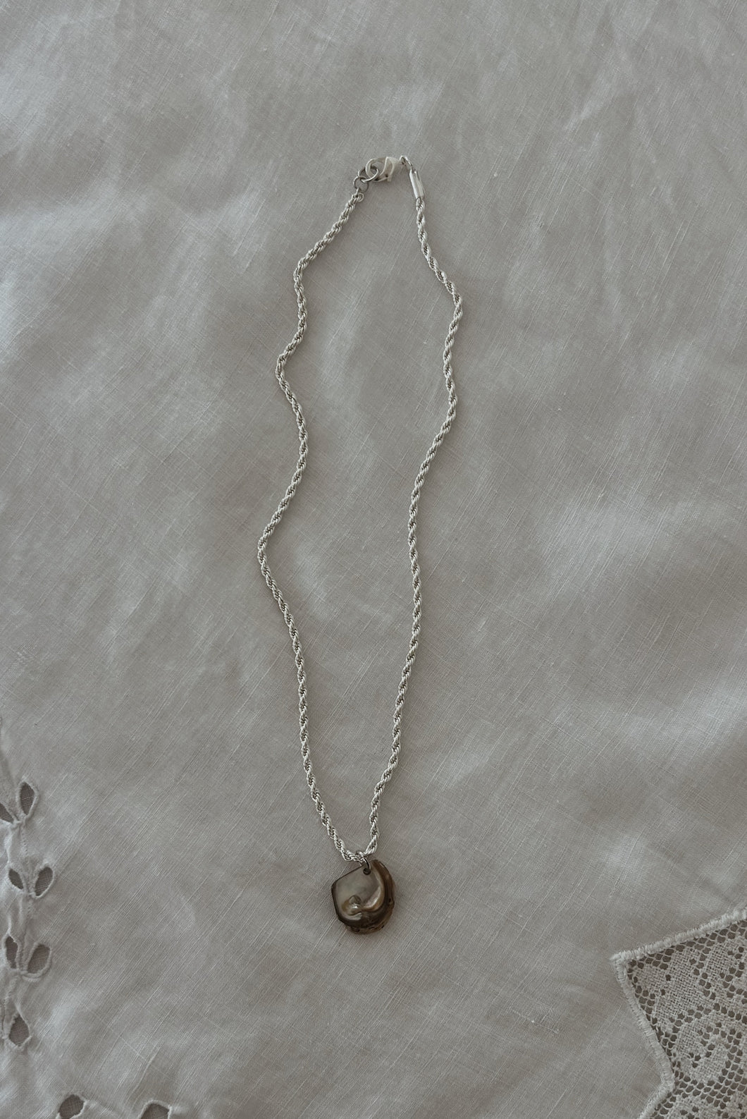 1990's MOTHER OF PEARL SHELL PENDANT ON SILVER PLATE TWIST CHAIN