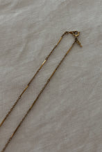 1930's BRASS RUNNER PENDANT ON 1970's GOLD FILL CHAIN